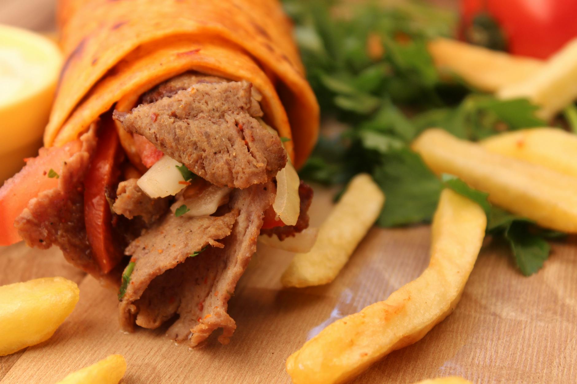 Kokoreç roulé servi avec des frites, gros plan sur cette spécialité de rue stambouliote.
